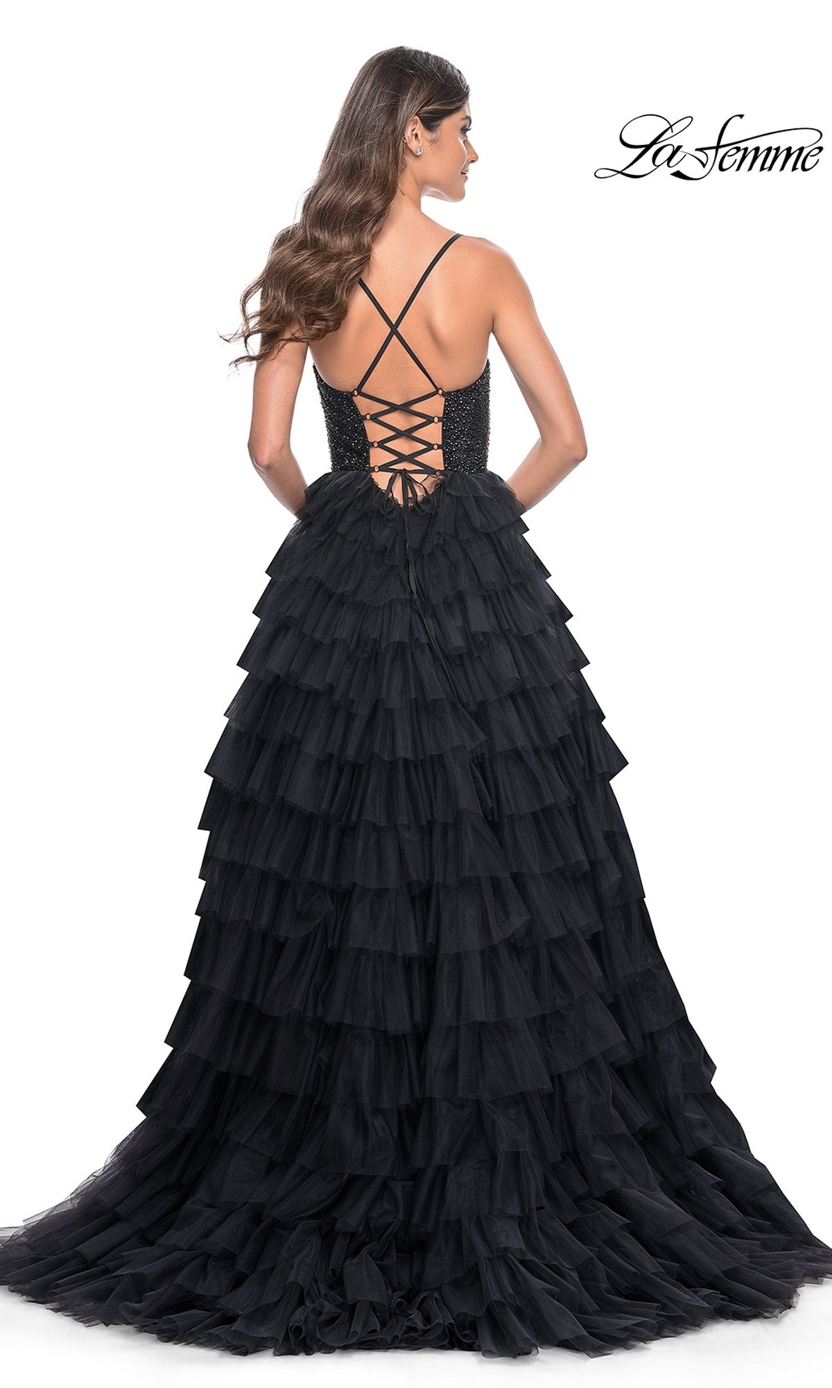 Woman wearing the La Femme Long Ruffled Prom Ball Gown 32002 with a lace-up open back, facing away from the camera.